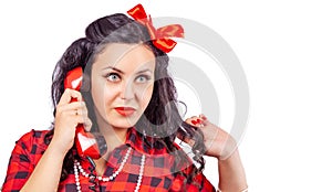 Portrait of brunette woman in red dress with phone in pinup stule
