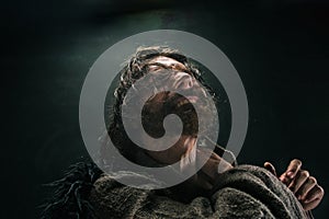 Portrait of a brutal bald-headed viking in a battle mail posing against a black background.