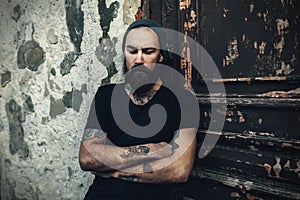 Portrait of brutal bearded man wearing blank t-shirt