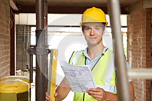 Portrait Of Builder On Site With Plans