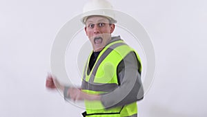 Portrait of builder in uniform dancing wild dance in the studio close up. Shooting in the studio on a white background.