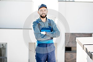 Portrait of a builder in uniform on the roof