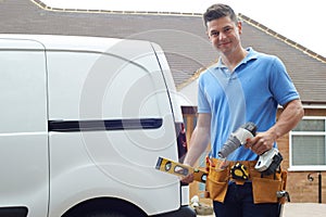 Portrait Of Builder With Van Outside House