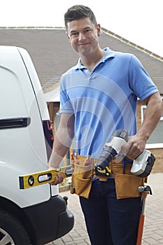 Portrait Of Builder With Van Outside House