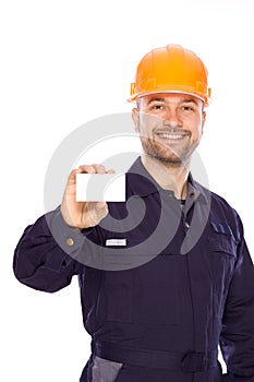 Portrait of the builder with visiting card on a wh