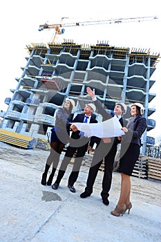 Portrait of builders standing at building site