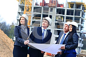 Portrait of builders standing at building site