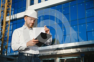 Portrait of building inspector with digital tablet on construction site
