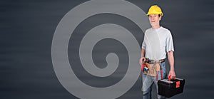 Portrait of building worker with tool belt and helmet