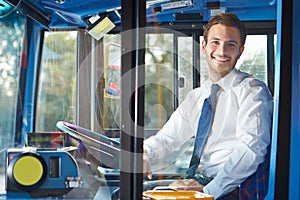 Portrait Of Bus Driver Behind Wheel