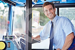 Portrait Of Bus Driver Behind Wheel