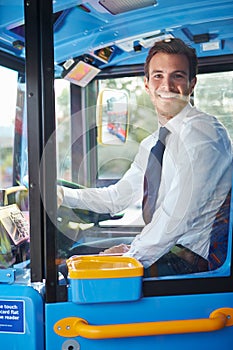 Portrait Of Bus Driver Behind Wheel