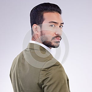 Portrait, business and Asian man with confidence, success and concentration against a studio background. Face, Japanese