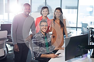 Portrait of business executives smiling at desk