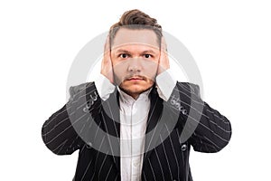 Portrait of business man covering ears like deaf concept