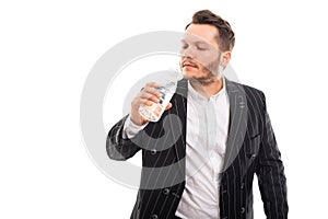 Portrait of business man drinking a bottle of water