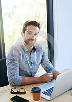 Portrait, business man and laptop in desk at office with pride in startup company as legal advisor. Entrepreneur, table