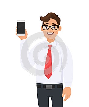 Portrait of business man showing a new brand, latest smartphone screen. Young man holding cell or mobile phone in hand.