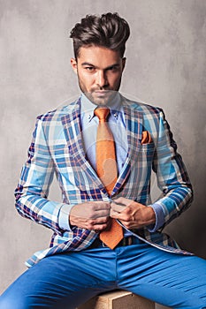 Portrait of a business man sitting on a wood box