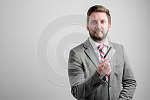 Portrait of business man wearing business clothes showing card