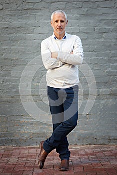 Portrait, business and mature man with arms crossed, entrepreneur and confident guy against a brick wall. Face, male