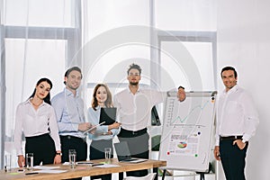 portrait of business people after business training standing at white board