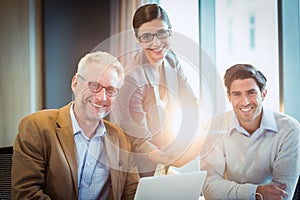 Portrait of business people discussing over digital tablet