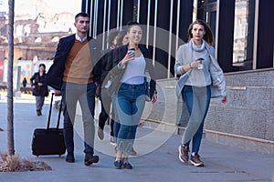 Portrait Of Business Team Outside Office. Meeting Concept. People Walking and drinking coffe, going to the office