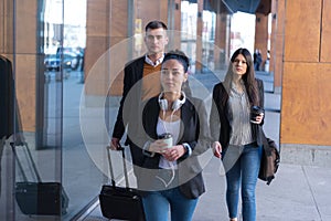 Portrait Of Business Team Outside Office. Meeting Concept. People Walking and drinking coffe, going to the office