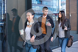 Portrait Of Business Team Outside Office. Meeting Concept. People Walking and drinking coffe, going to the office