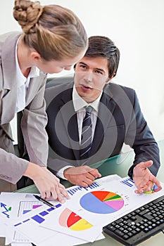 Portrait of a business team studying statistics with a computer