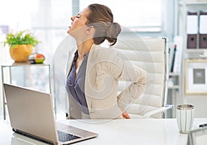 Portrait of business woman with back pain