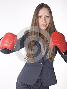 Portrait of business woman boxing in red gloves. business activity