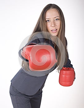 Portrait of business woman boxing in red gloves. business activity