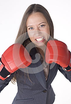 Portrait of business woman boxing in red gloves. business activity