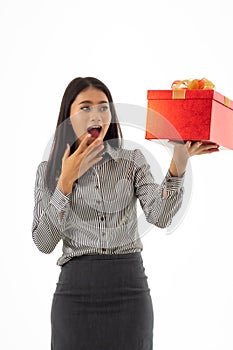 Portrait of business woman looking to the gift.Asian young lady holding beautiful red present box with surprise facial expression