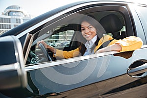 Portrait of a business woman sitting in her new car