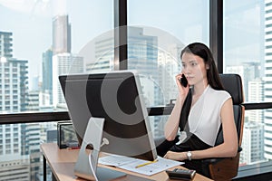 Portrait of Business Woman is Talking on Mobile Phone in Office Workplace, Attractive Beautiful Businesswoman is Talking on