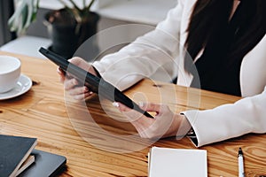 Portrait of a business woman using a tablet computer for data analysis, marketing, accounting