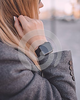 Portrait of business woman wearing in digital smart watch