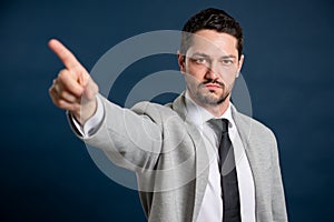 Portrait of business young handsome male showing denial gesture