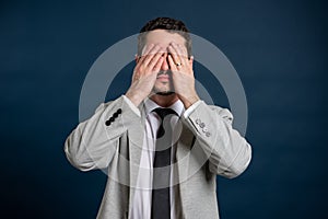 Portrait of business young male covering eyes like blind gesture