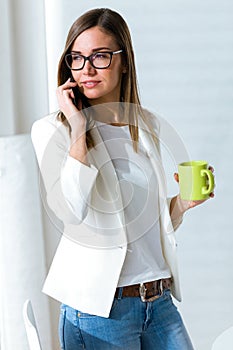 Business young woman using her mobile phone in the office.