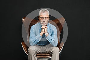 Portrait of businesslike gentleman 50s with grey hair and beard