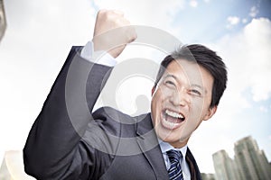 Portrait of Businessman Cheering with Fist raised, Outdoors, Beijing