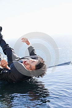 Portrait of a businessman falling into water