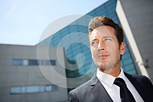 Portrait of businessman in front of modern building