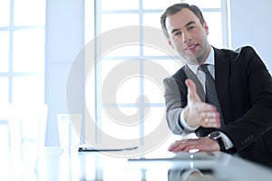 Portrait of businessman giving hand for handshake