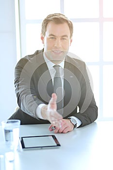 Portrait of businessman giving hand for handshake