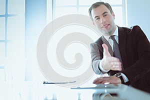 Portrait of businessman giving hand for handshake